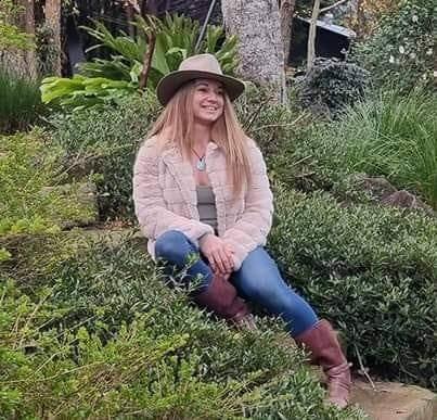 Naomi Lewin relaxing in a lush garden in Maleny