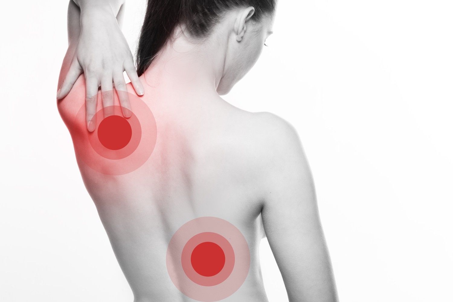 Person holding upper and lower back with red highlighted areas indicating pain or discomfort