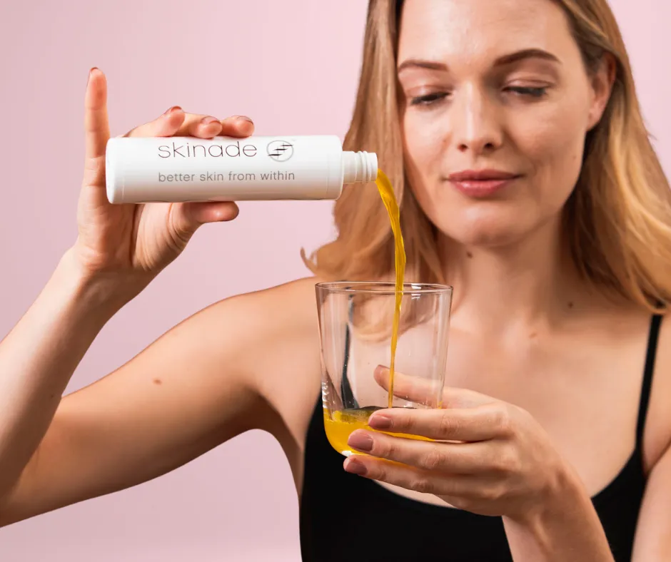 woman pouring drinkable collagen supplement, Skinade, into glass