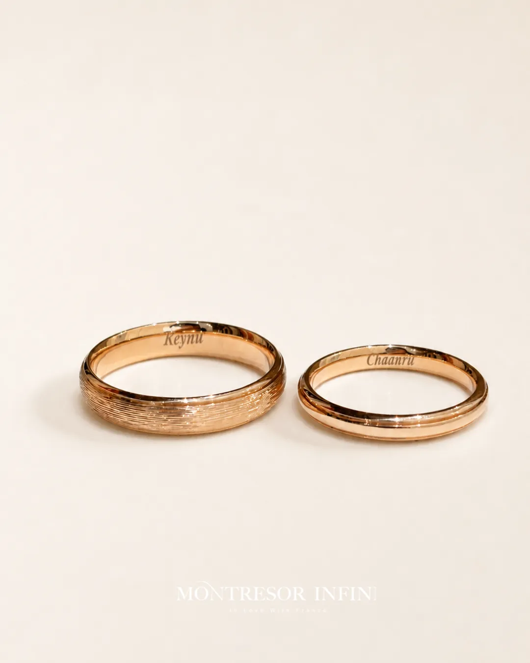 Custom rose gold wedding bands with engraved names, brushed texture, and minimalist detailing by Montresor Infini.
