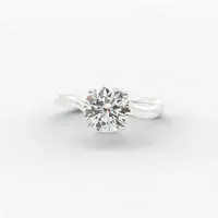Montresor Infini round brilliant diamond engagement ring with a wavy pavé diamond band in white gold, combining modern elegance with timeless romance.
