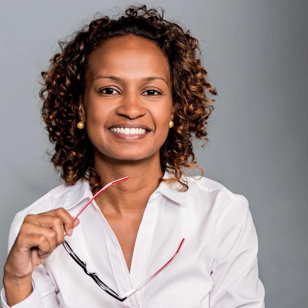 business woman holding her glasses smiling