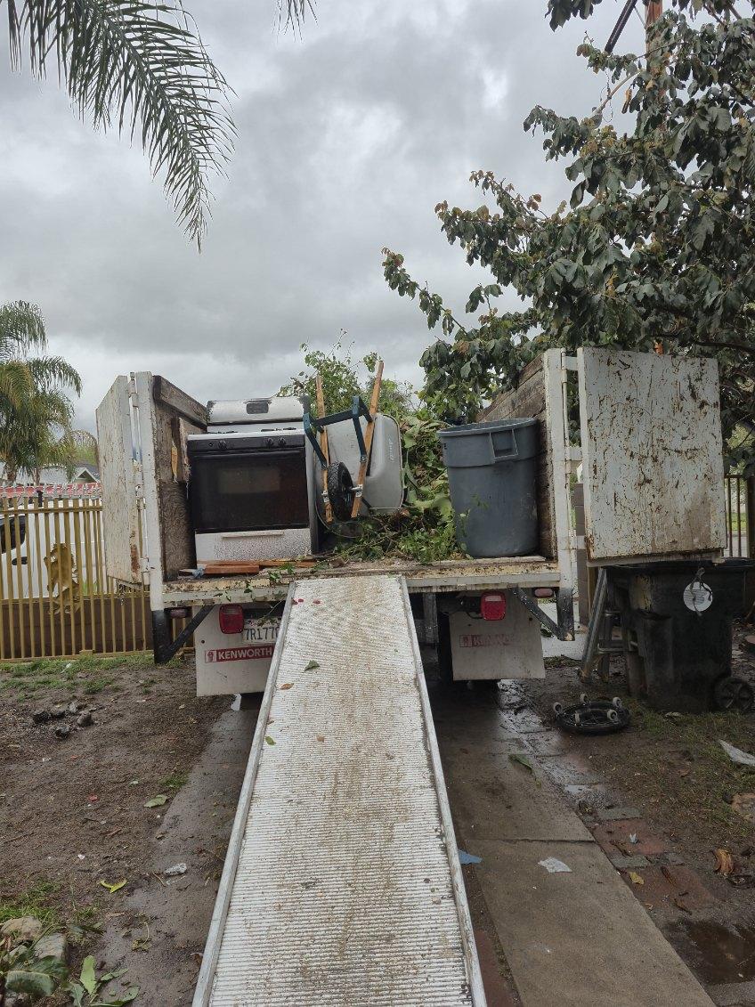 Truck loaded with an old stove and yard debris - Blanco's Hauling and Handyman Service in San Bernardino