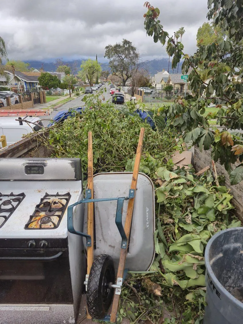Truck bed loaded with an old stove, wheelbarrow, and yard debris - Blanco's Hauling and Handyman Service in San Bernardi