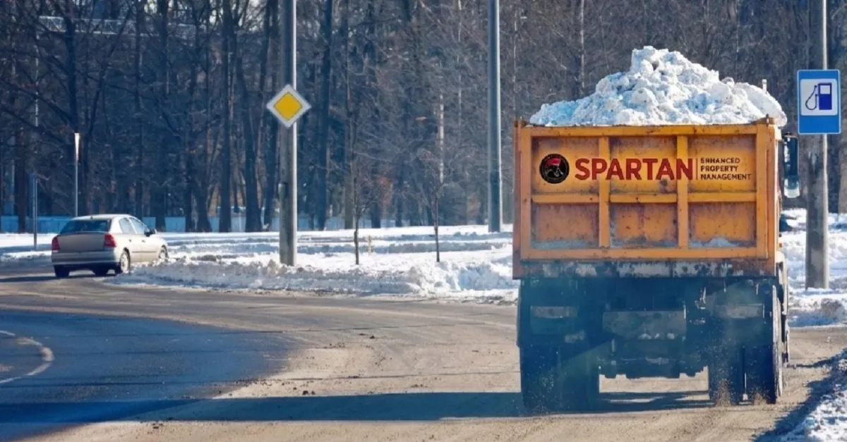A snow removal truck carrying snow on a road.