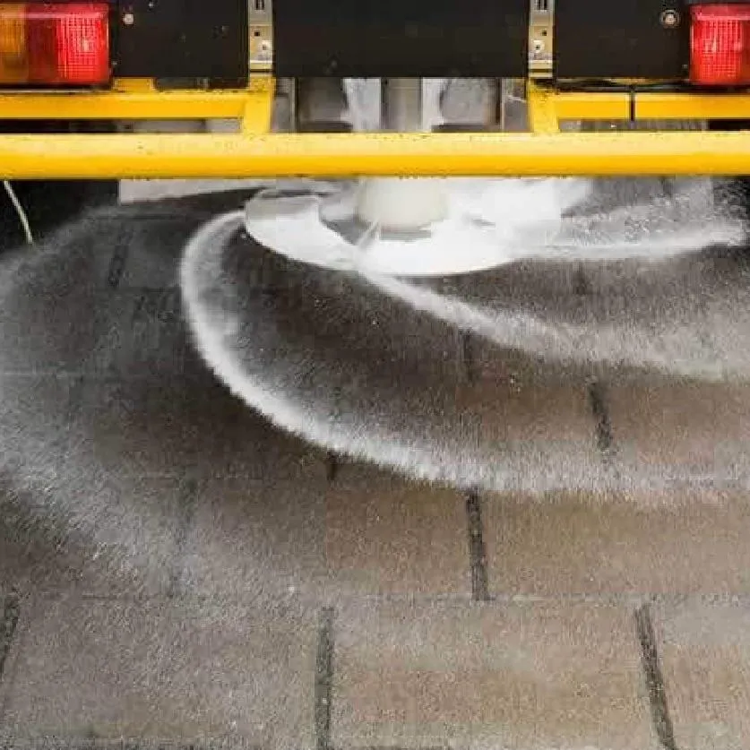 A truck sprinkling Calcium Chloride on a road full of snow to prevent Icing