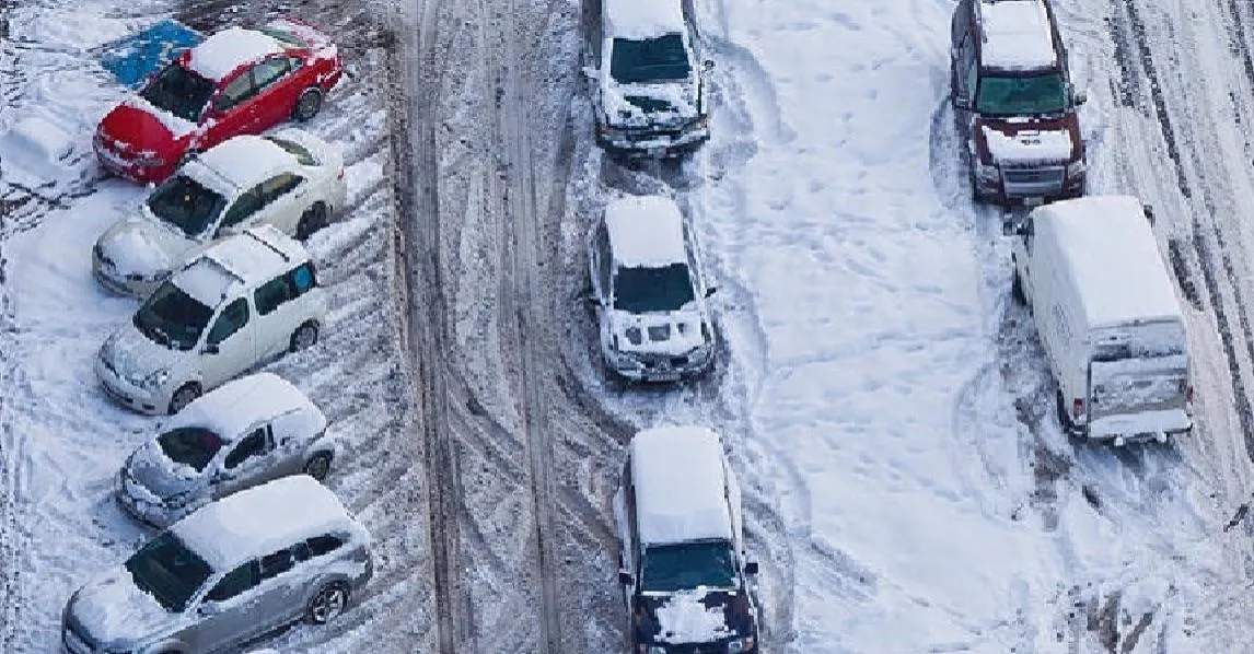 Cars stuck in parking lot due to heavy snow. 