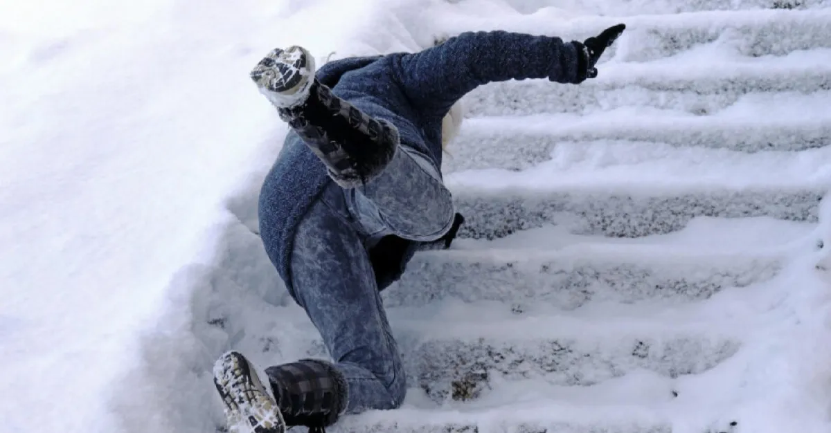 A person falling down from the stairs after ripping down due to black ice.