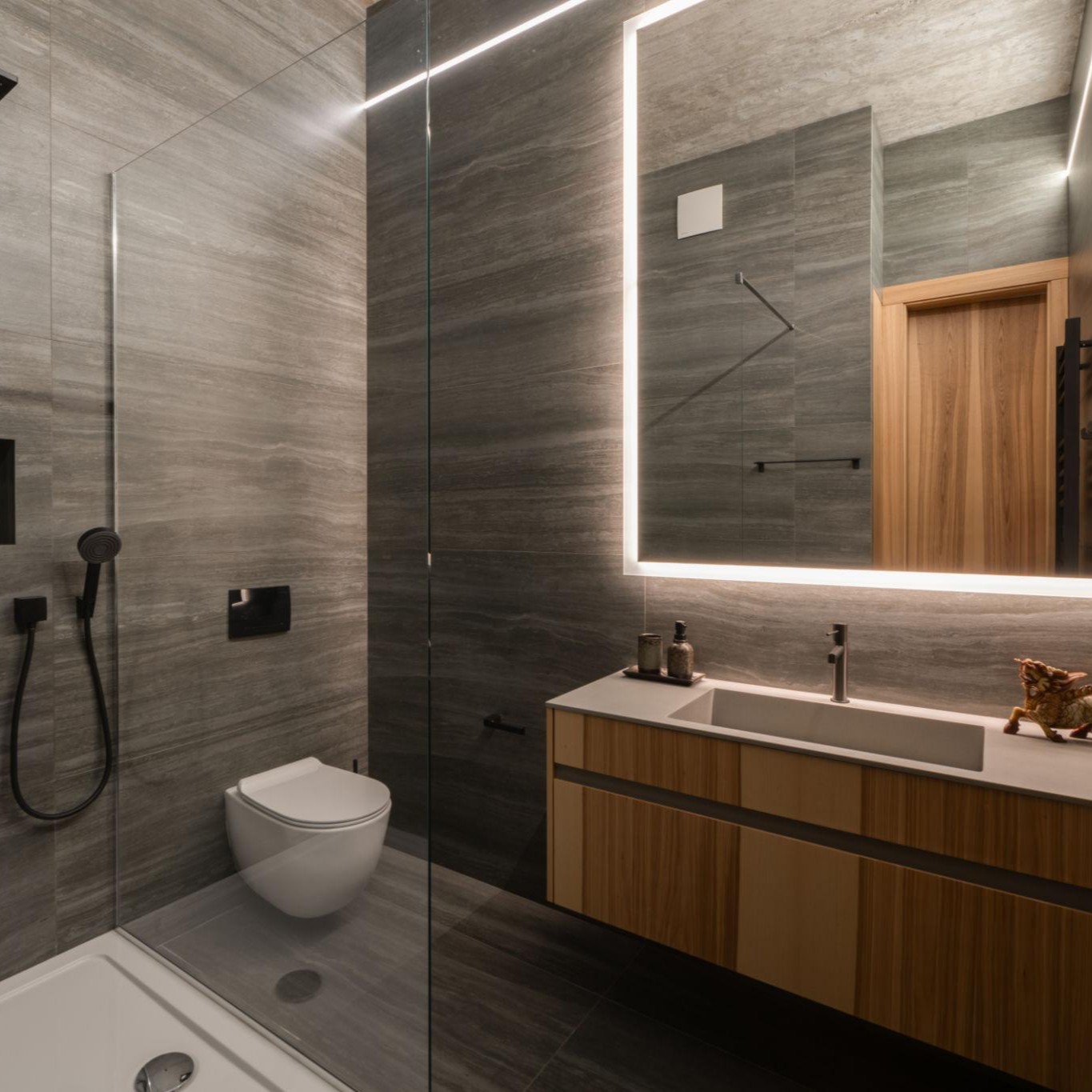 A bathroom renovation showing a vanity and fixture swap with a sleek modern sink and efficient lighting alternatives.