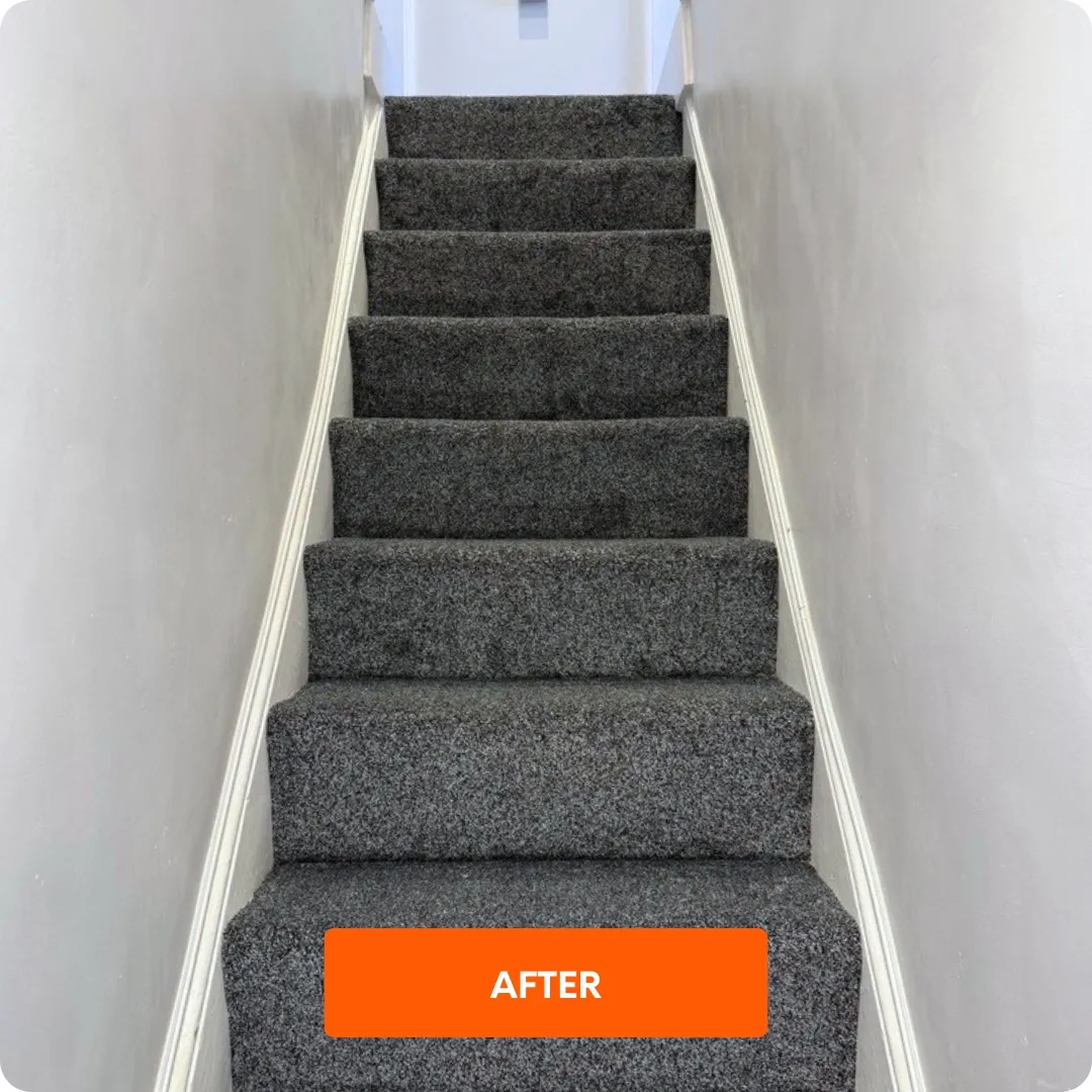 Renovated staircase with fitted grey carpet, refreshed woodwork and redecorated walls 