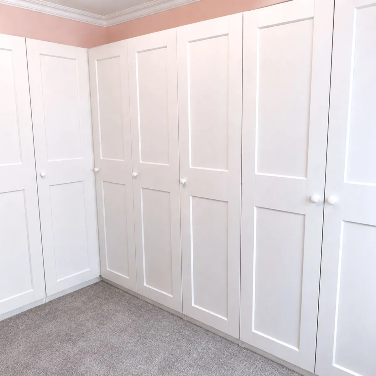 Floor-to-ceiling fitted wardrobes installed to create a seamless built-in bedroom storage solution 