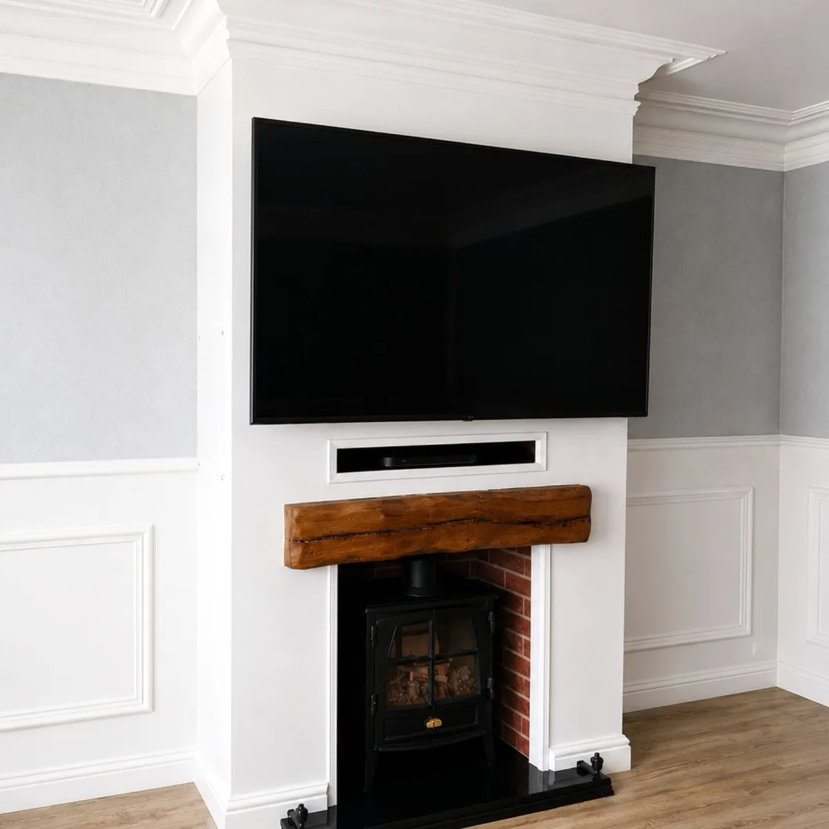 Custom living room media wall with fireplace, decorative panelling and bespoke joinery 