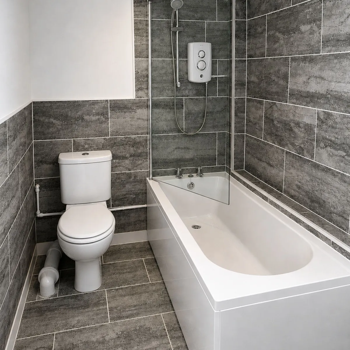 Completed bathroom renovation featuring full-length bath, electric shower and stone-effect tiling 