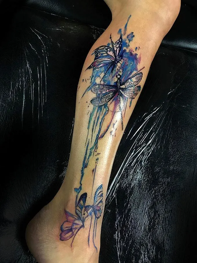 person in blue denim shorts and white nike sneakers standing on gray concrete floor