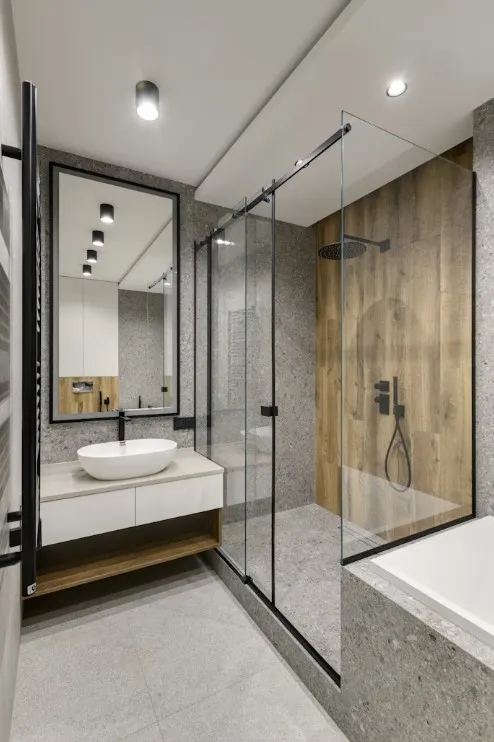 black and grey shower room with glass shower divider