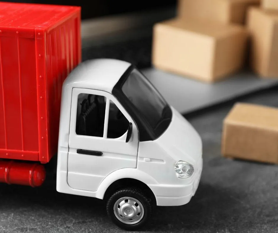 A toy truck and boxes, representing a man and van service