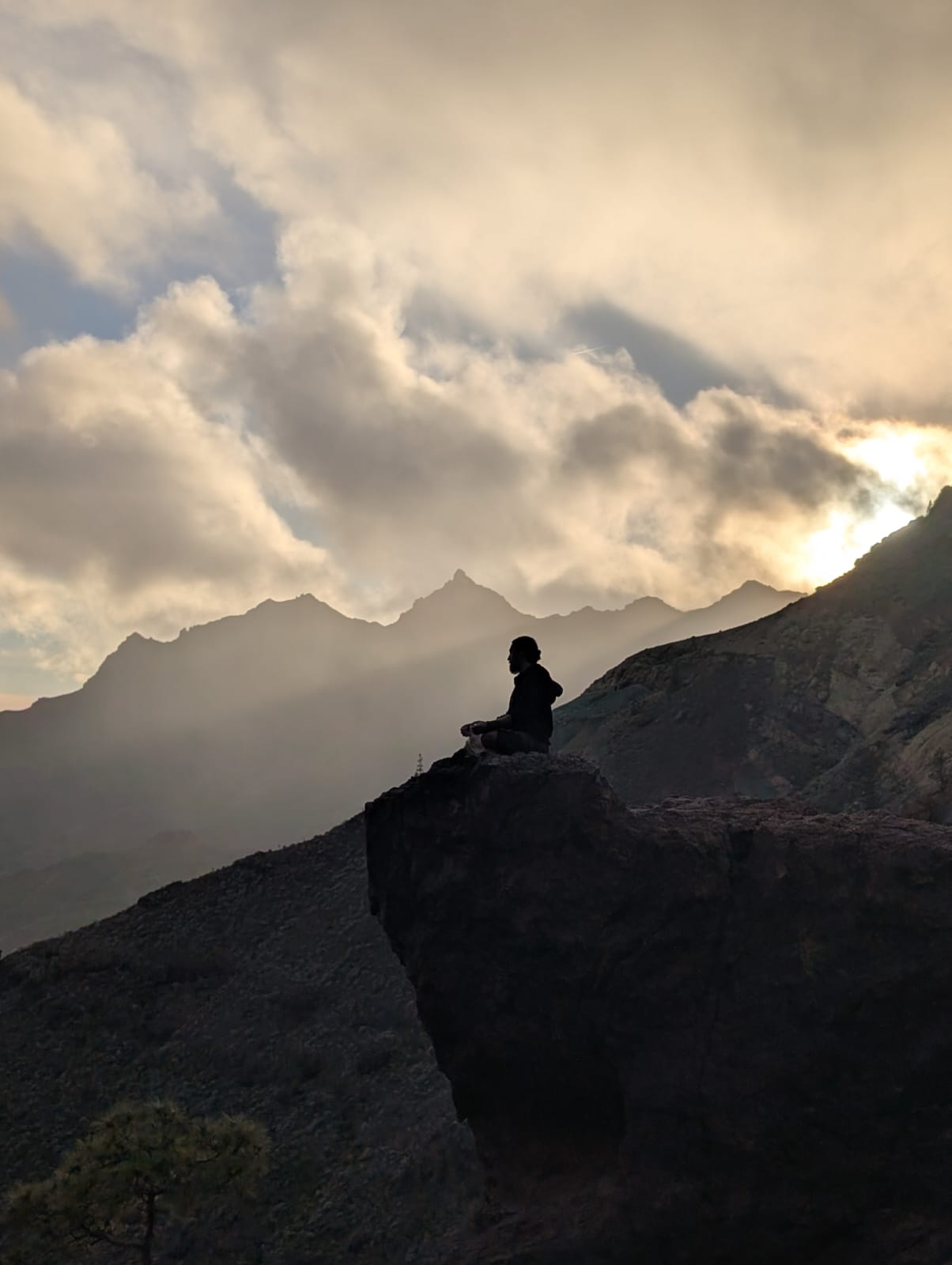 Rory Condor, the founder of Sunyata Sound Healing, is pictured sitting on the floor surrounded by sound bowls.