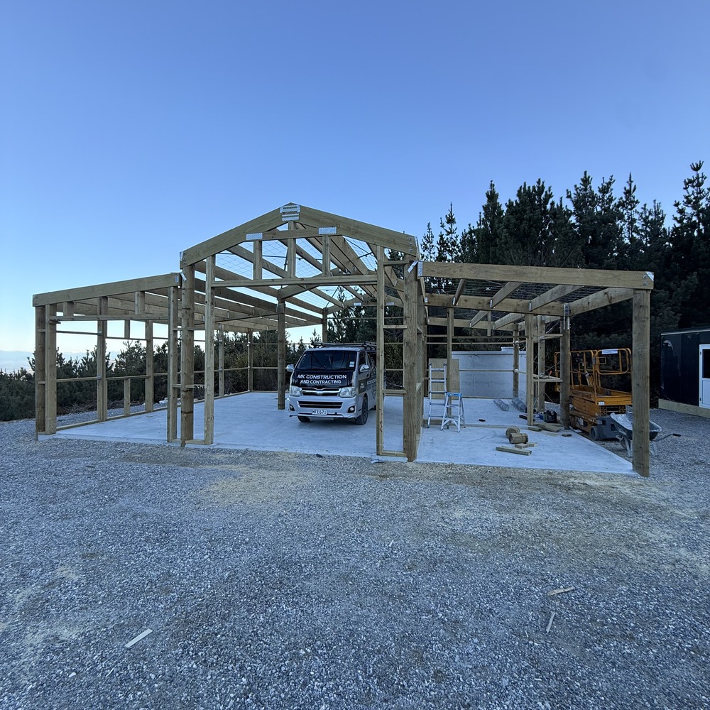 MK Construction and Contracting timber shed frame under construction on a rural hilltop site with company van on the new concrete pad