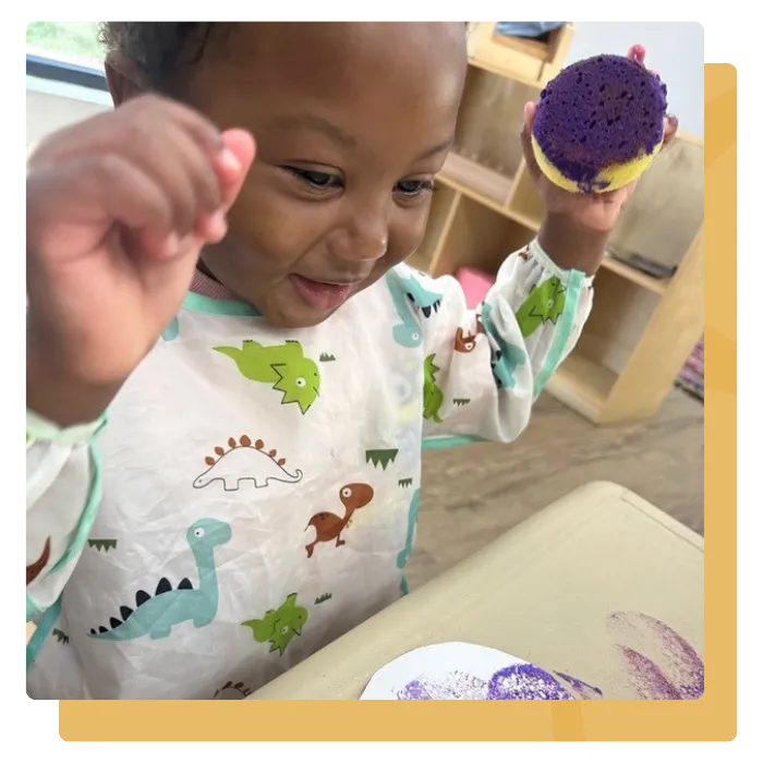 child painting in childcare