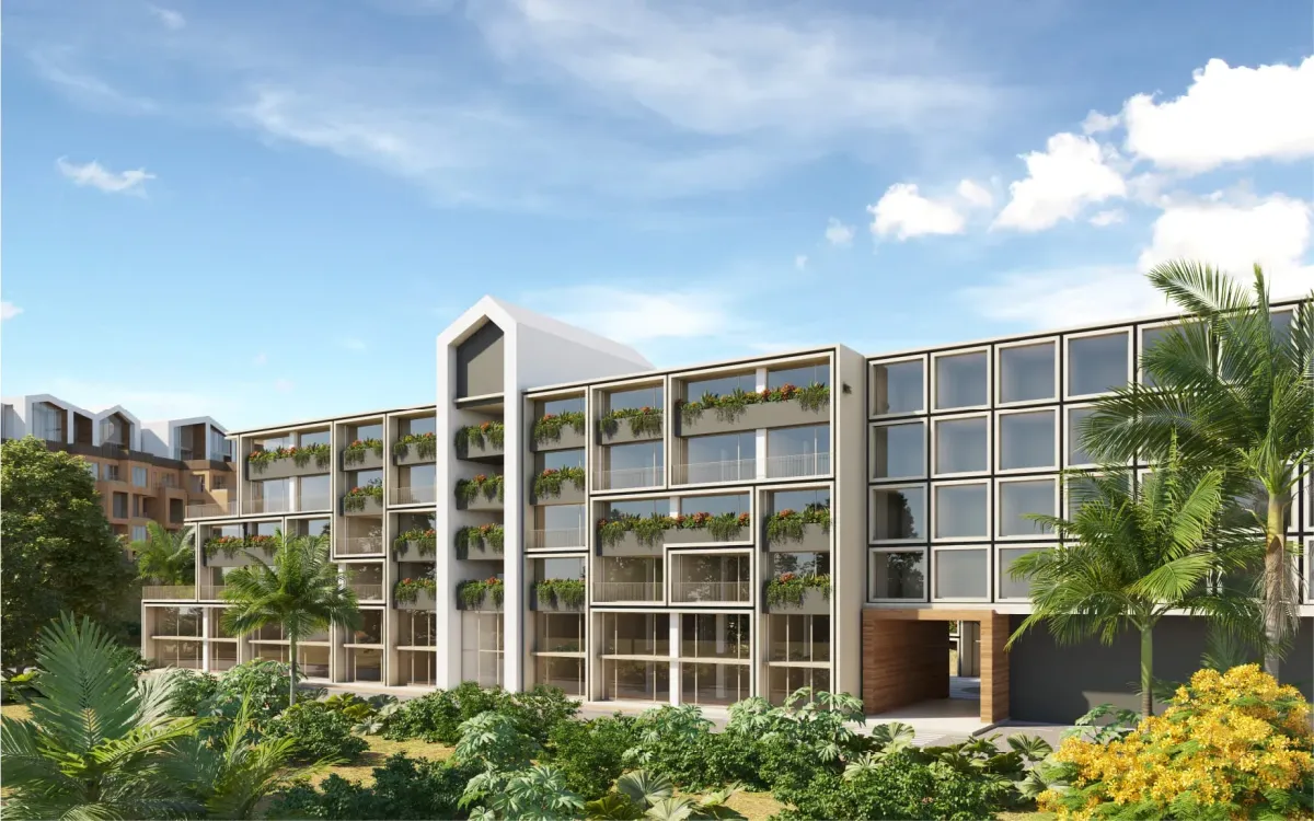 Fachada exterior del edificio UStay con iluminación cálida y enfoque en la entrada y el letrero.