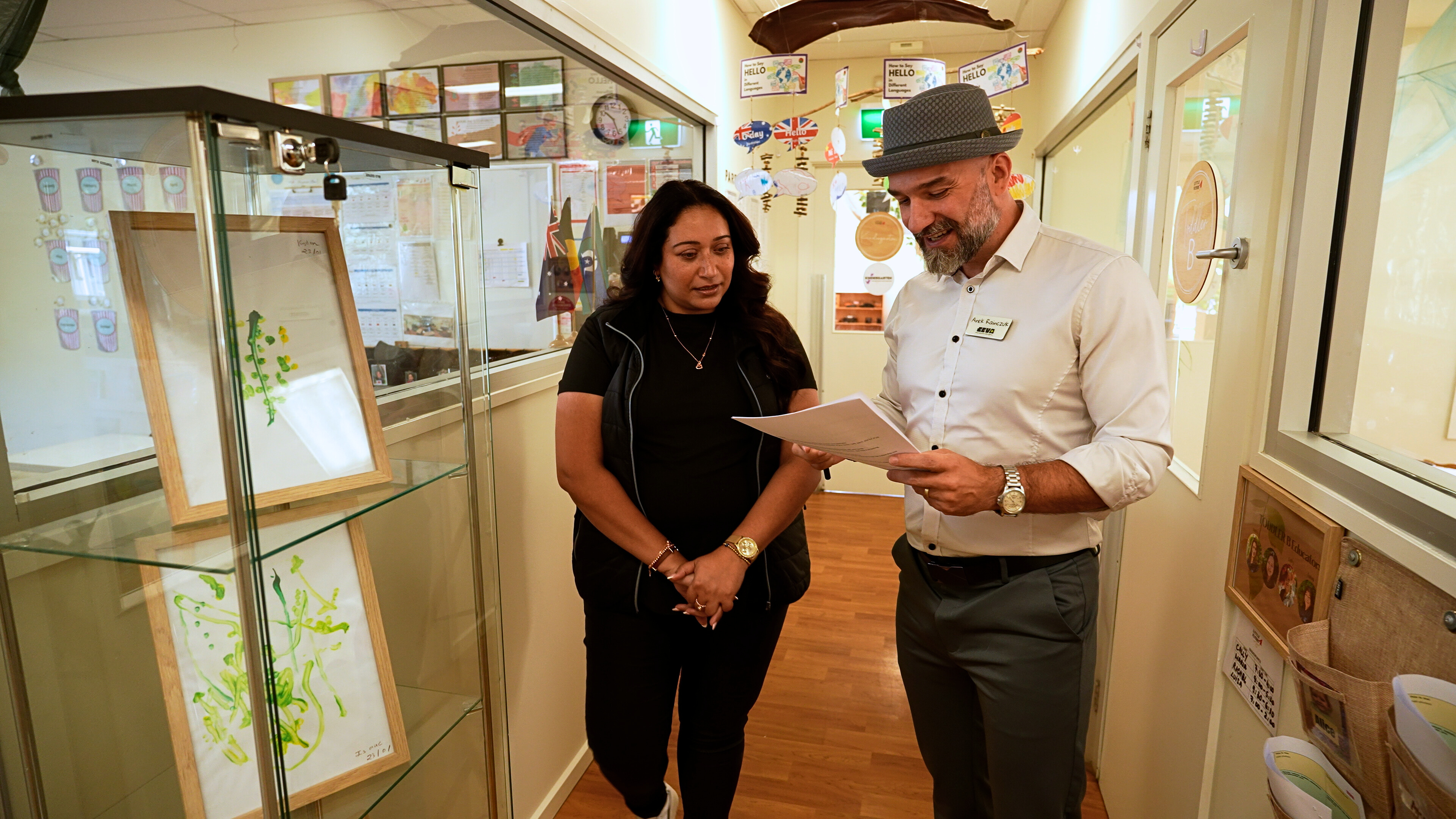 childcare centre walkthrough video featuring Arek and a learning centre director reviewing documents in hallway, showcasing leadership, collaboration, and quality standards in early learning environment