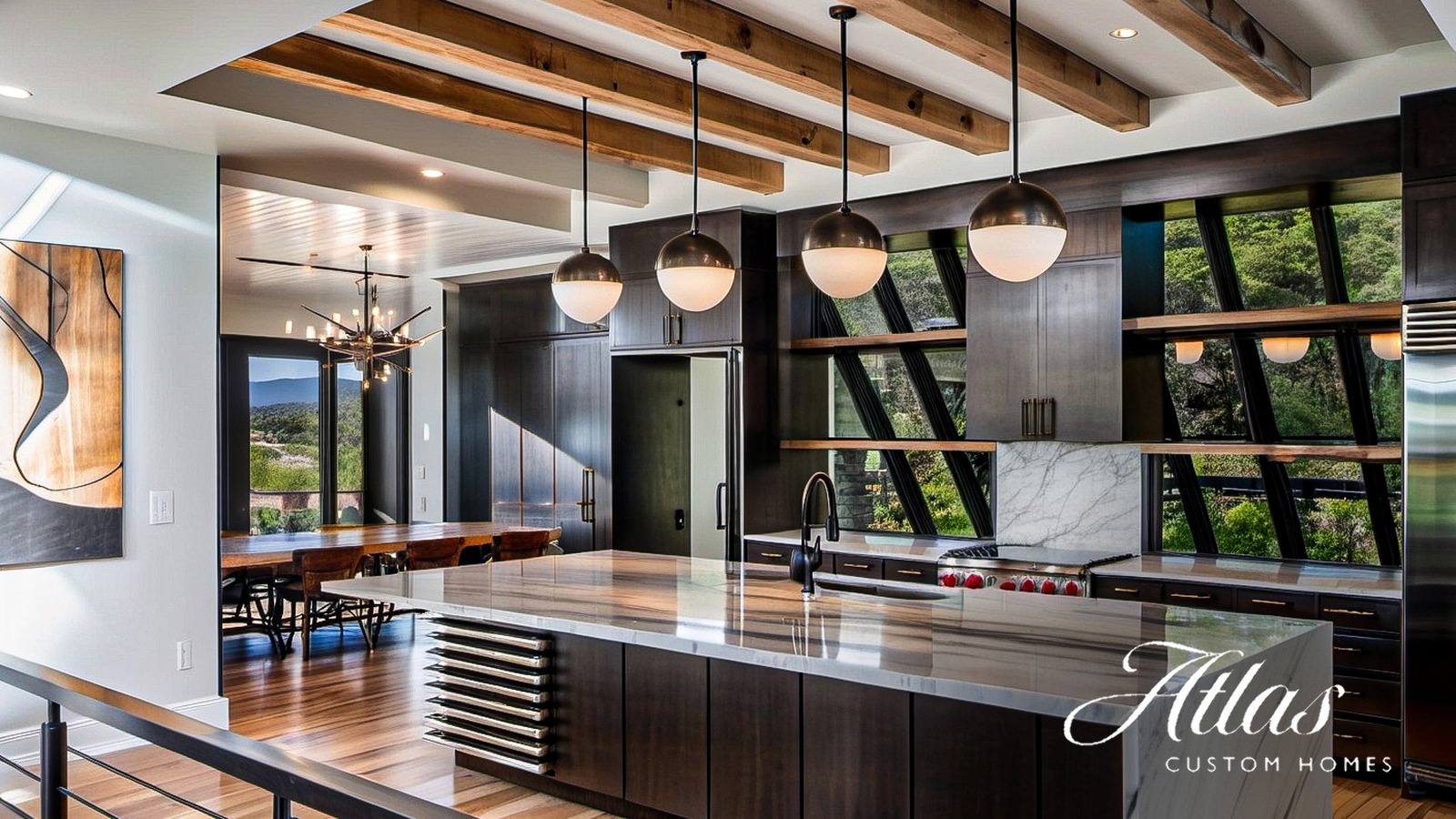 Custom kitchen in an Atlas Custom Homes build with reclaimed wood beams, a book-matched marble waterfall island, dark walnut cabinetry, and steel-framed windows overlooking the Central Texas Hill Country
