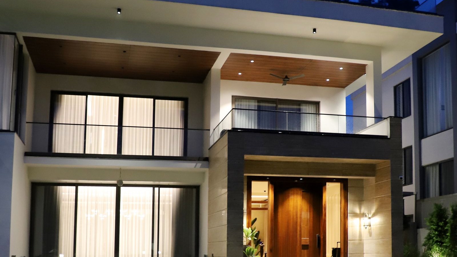 Modern luxury custom home exterior lit at dusk in Central Texas