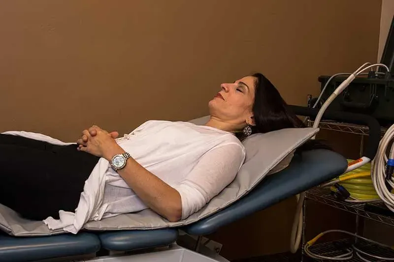 Senior using PEMF comfortably at home