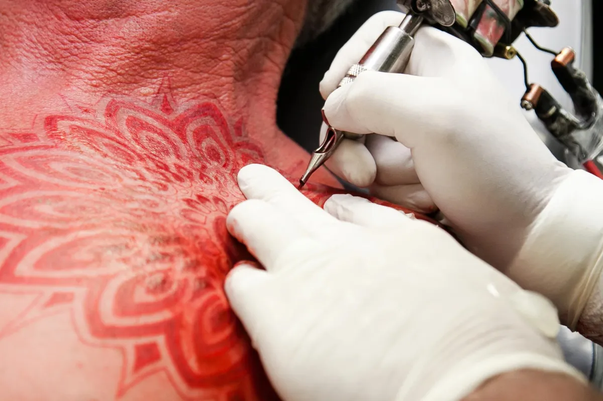 black and white tattoo on persons leg