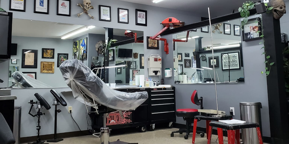 a man getting a tattoo on another man's arm