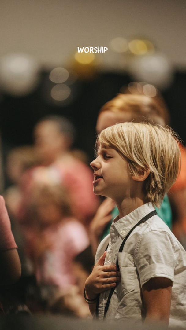 Family with parents and young child reading the Holy Bible together during home devotion, teaching children about worship, prayer, and Christian faith in a Christ-centered family environment.