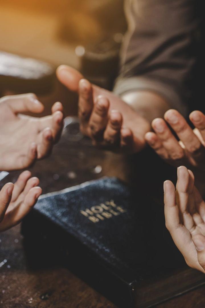 A touching image of a family holding hands in prayer, demonstrating the power of unity and faith. When families pray together, they support one another spiritually and build deeper, lasting relationships.