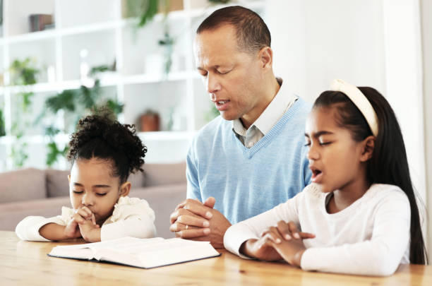 Fatherly leadership and Christian father responsibilities through prayer, biblical parenting, and Christian family faith.