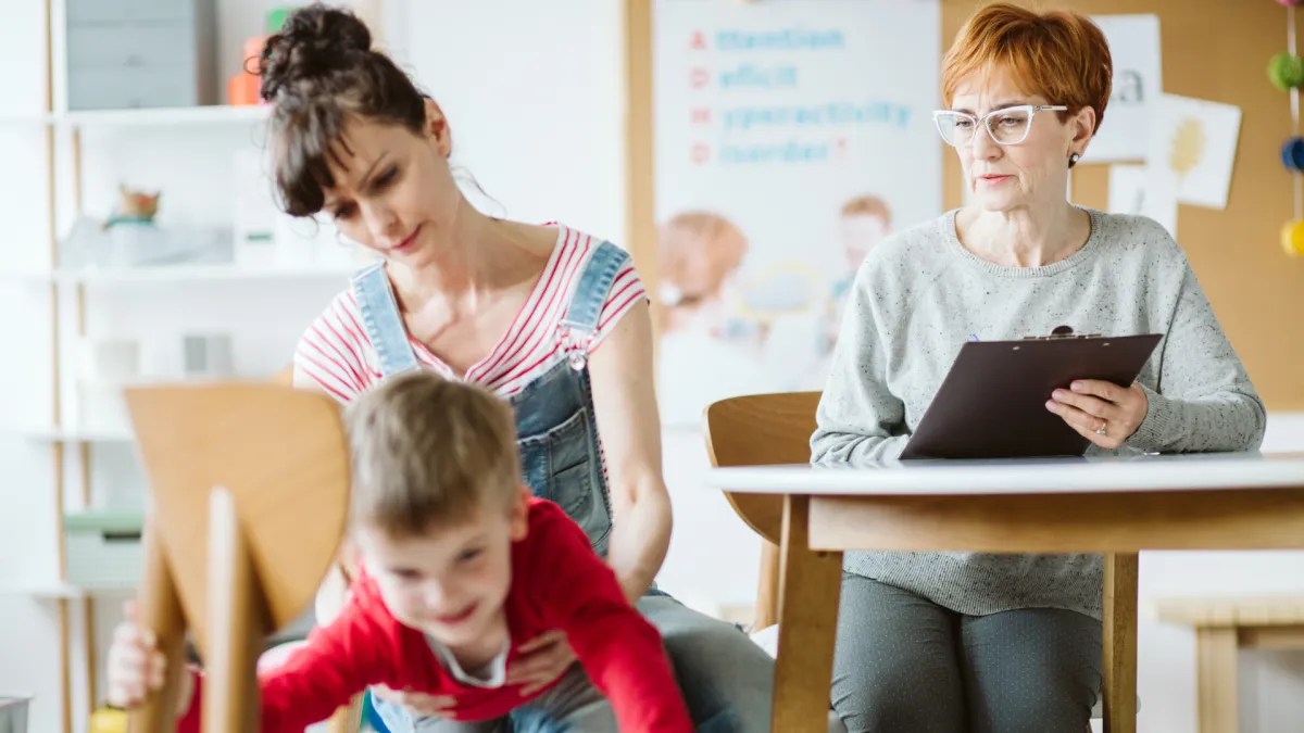 woman placing sticky notes on wall