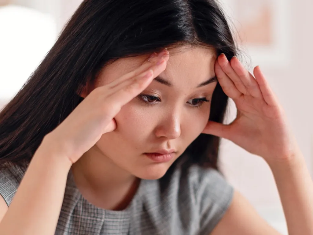 woman placing sticky notes on wall