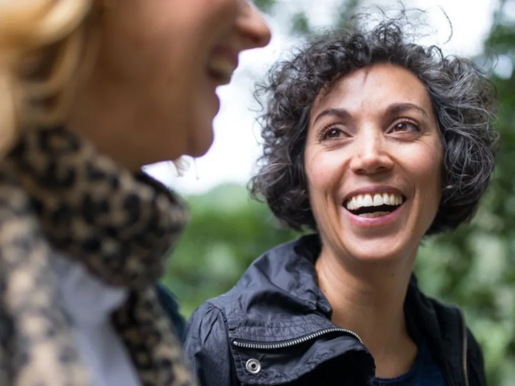 woman placing sticky notes on wall