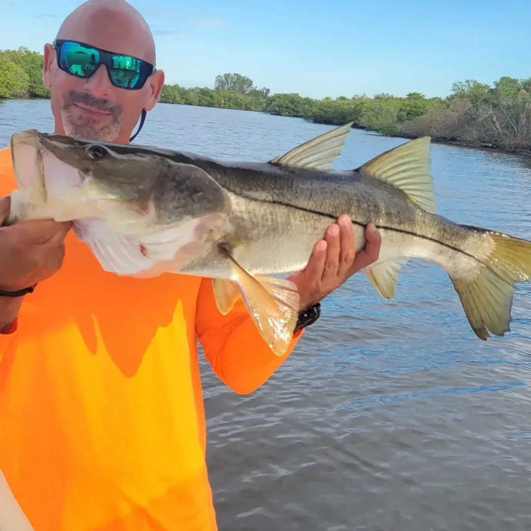 a person in a small boat on a large body of water