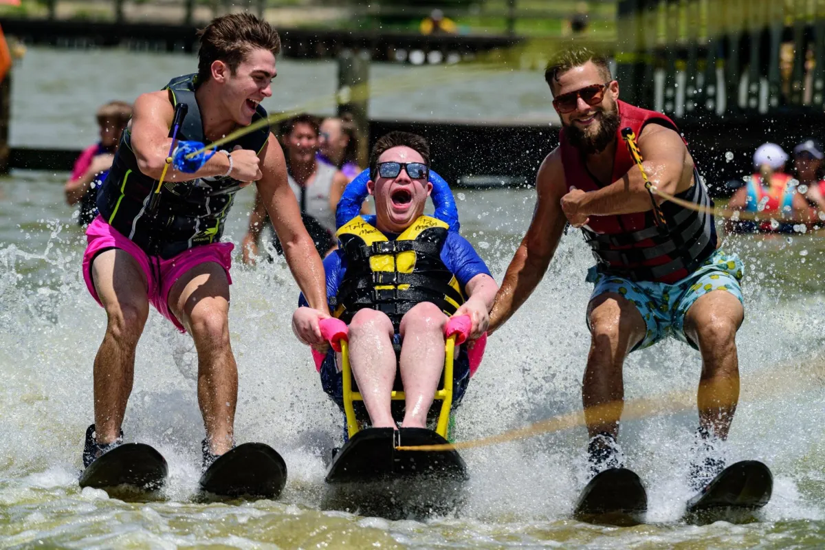 Adaptive water skiing session with Texas Adaptive Aquatics, helping a child with disabilities experience the thrill of the water