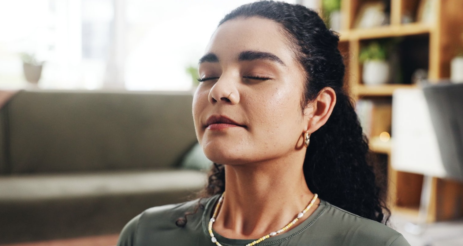 person in orange scarf holding silver round bowl