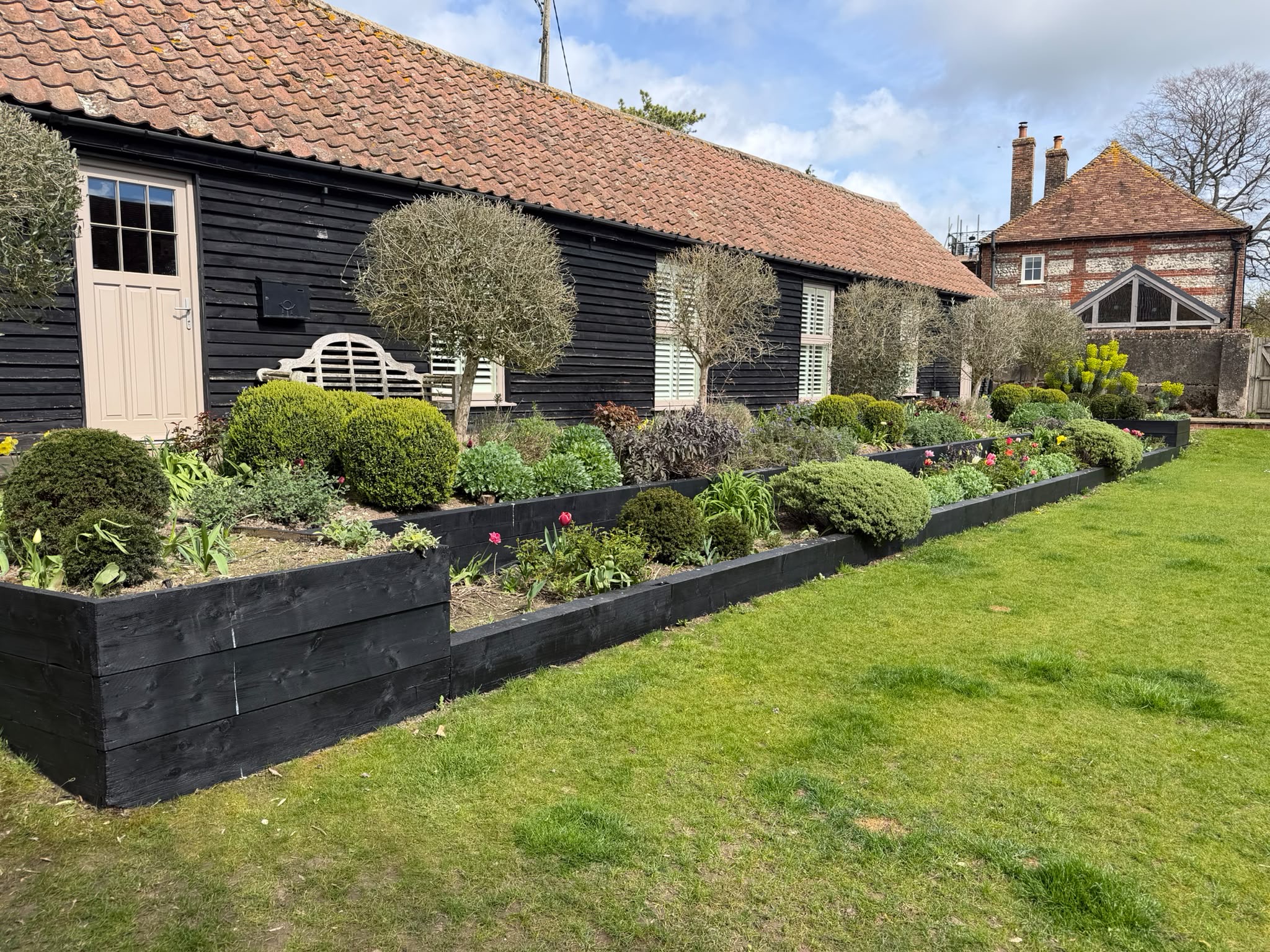 Lush planting design around a garden pathway