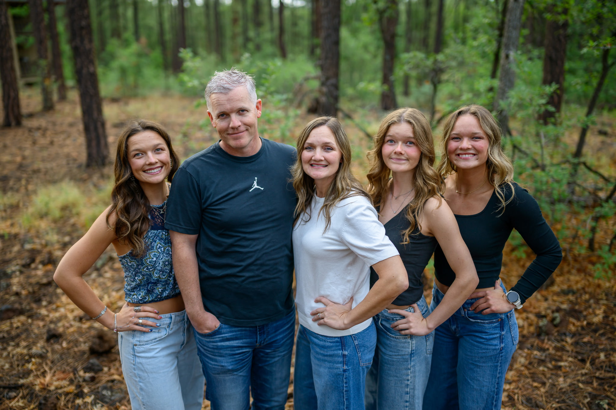 Three founders, a man and a woman in their 30s, sitting together on a sunlit porch, both wearing faith-themed shirts. They hold hands, smiling with gratitude, a car key resting between them, symbolizing their survival. The scene radiates hope and unity.