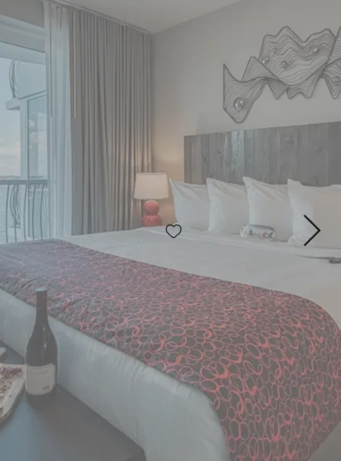 a building with two windows and a tree in front of it