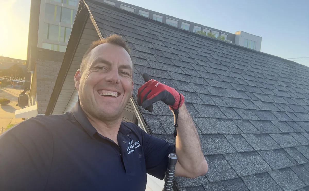 a row of rooftops with a clock tower in the background
