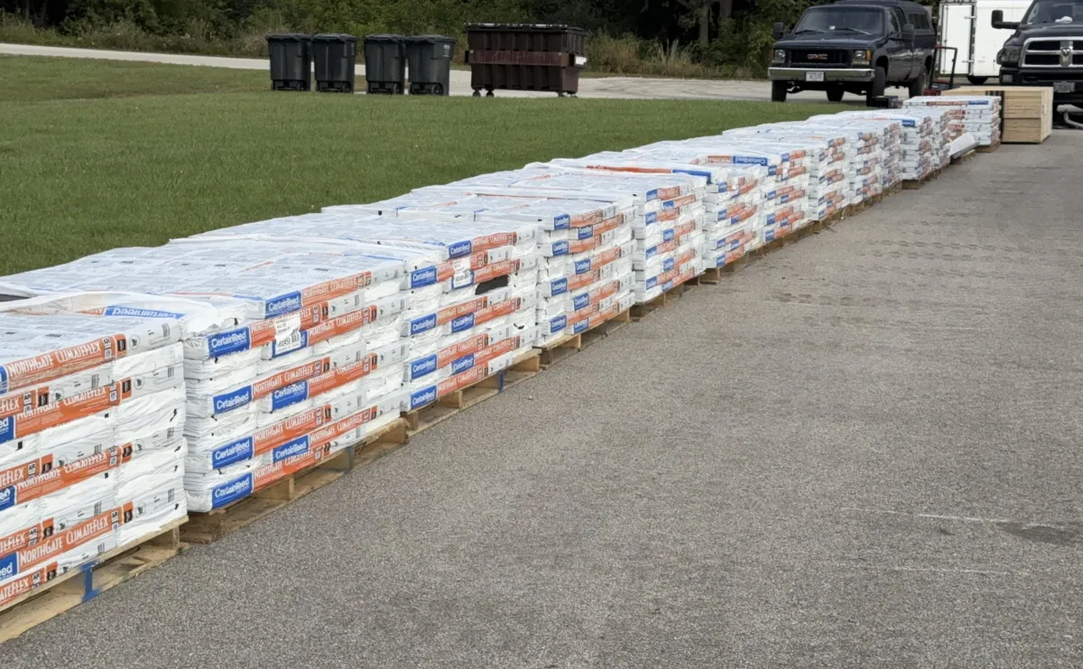 two men working on the roof of a house