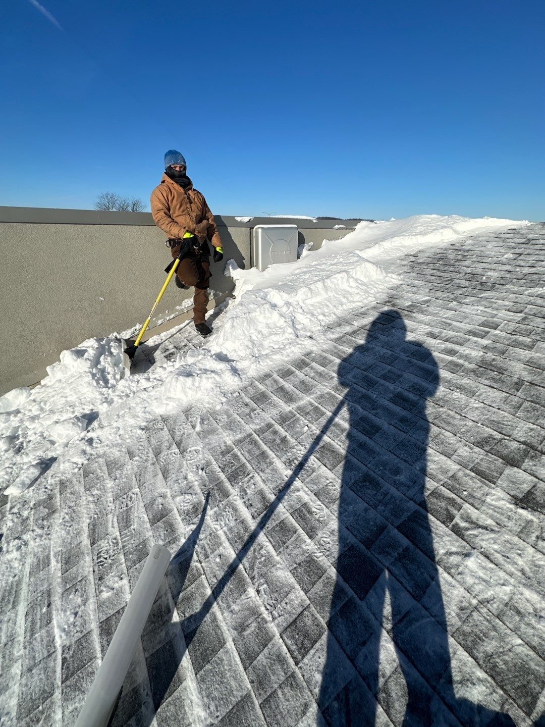 two men working on the roof of a house