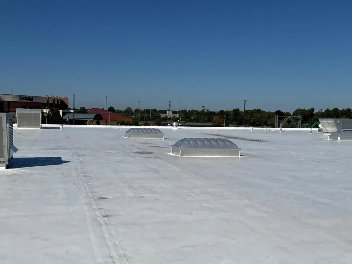 a row of rooftops with a clock tower in the background