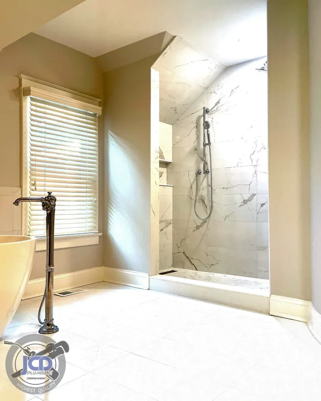 High-end bathroom renovation featuring freestanding tub and custom shower plumbing for a residential home