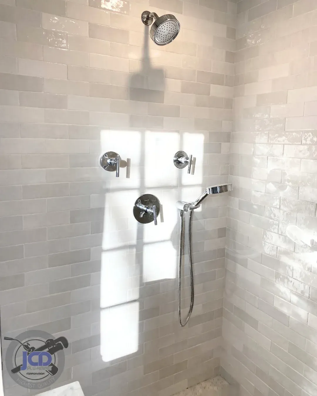 Residential shower plumbing installation with modern fixtures in a luxury bathroom remodel
