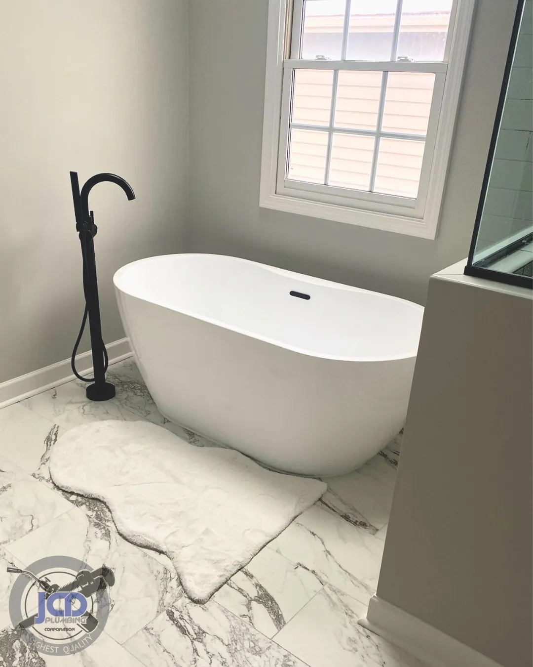 Freestanding bathtub plumbing installation with floor-mounted faucet in a luxury residential bathroom