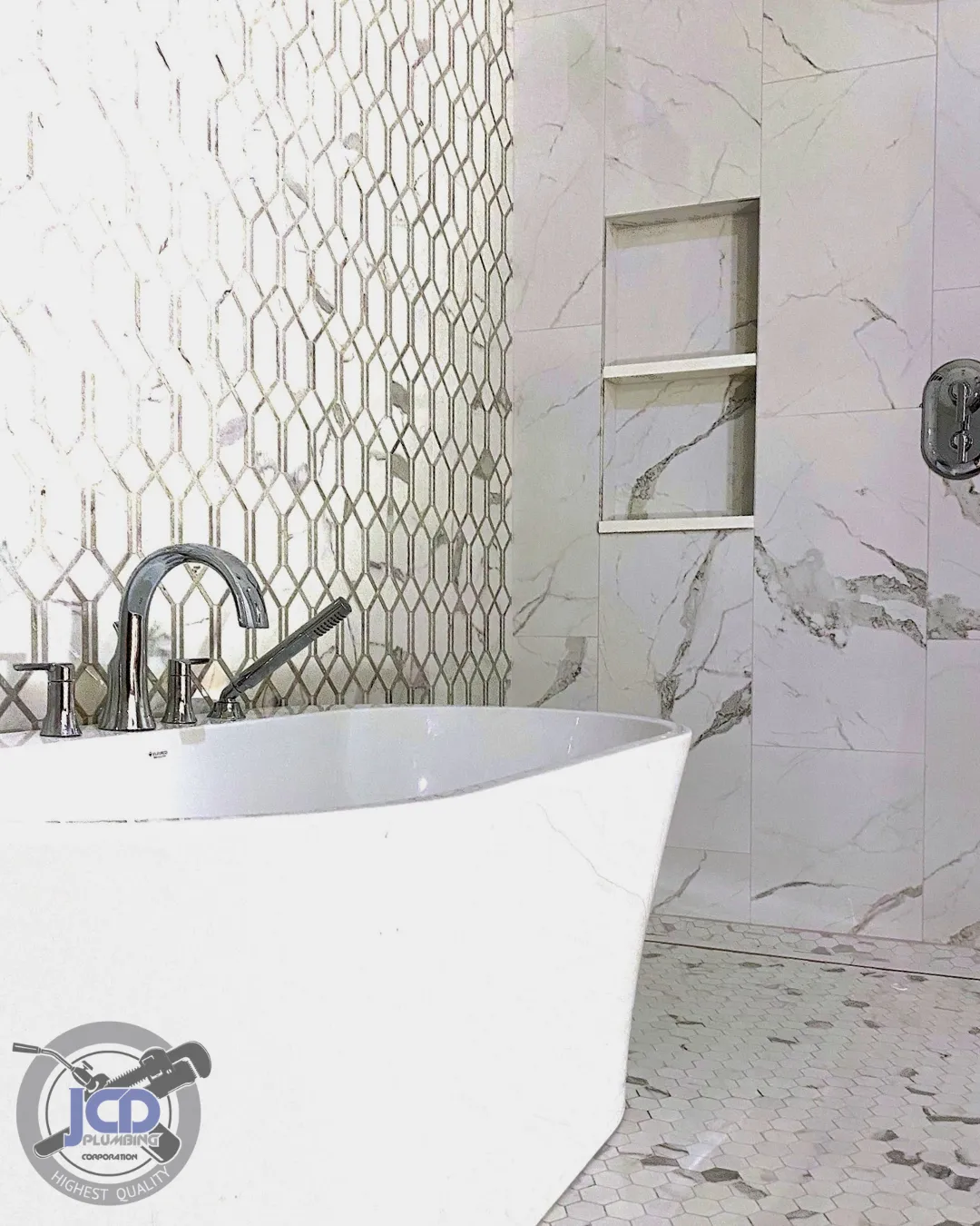 Luxury bathroom remodel with custom shower plumbing, glass enclosure, and brass fixtures installed by JCD Plumbing Corporation